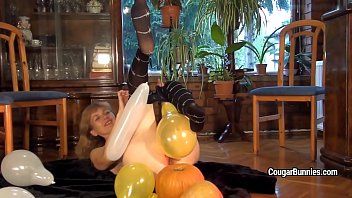 mature model doris dawn plays with balloons and.